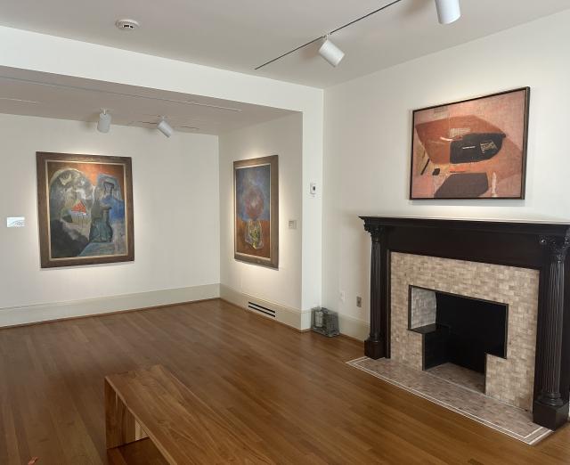 Installation photo with Gallery D with 3 artworks on the wall and a fireplace